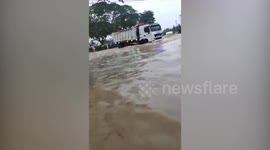 Residents Ride Huge Trucks To Escape Flooded Village In The Philippines