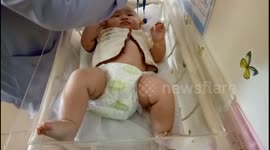 Adorable baby having monthly check up in hospital