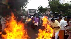 Miraculous escape of a party cadre while burning an effigy in a protest  in Southern India