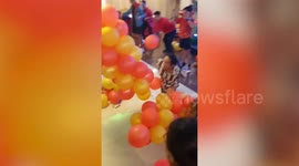 Filipino staff play hilarious Christmas party popping balloons