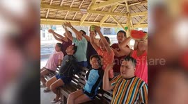 Filipino workers play hilarious watermelon eating game at Christmas party