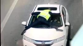 Chinese motorist drives off with officer on bonnet to avoid police check