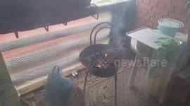 a bosnian man lockdown preparing a barbecue on the balcony as the corona virus pandemic arose.