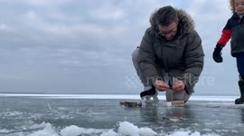 Canadian dad gives kids a science lesson when he finds methane bubbles under the ice and sets them alight