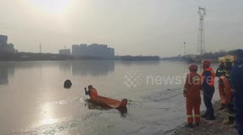 Firefighters break ice to rescue man trapped in frozen river in northern China
