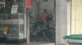 Passersby get frighten by a baby doll which riding on a bike at shop in Malaysia