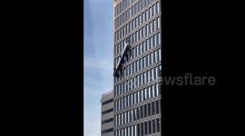 2 workers rescued after dangerously dangling off Baltimore building