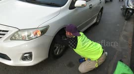 Cat rescued after getting stuck in car bumper in Thailand