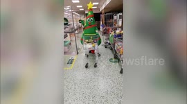 This hilarious video shows a woman dressed as an inflatable Christmas tree bopping about as she does her grocery shopping