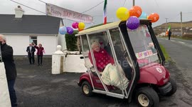 Hundreds of locals on a small island joined a Christmas parade to a woman's house - to celebrate her 100th birthday