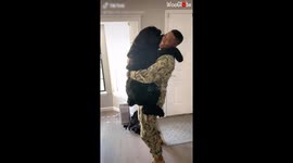 Giant schnauzer welcomes back US owner from military service with huge hug