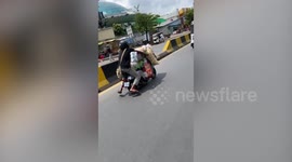 Cambodian man rides motorcycle stacked with shopping