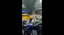Cars swept away by heavy flooding in streets of Indonesian town