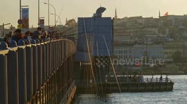 Hundreds of fishermen set up lines on historic bridge in Istanbul