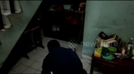 Firefighters Evacuate a Lizard Entering a Citizen's House. East Jakarta. Indonesia