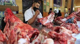 MEXICAN  butcher cuts a head of beef in one of the shops of the Municipal Market during food sales for the New Year's dinner