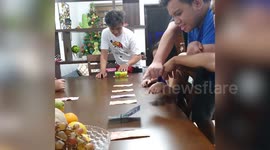 Filipino family play fun Christmas game by rolling can over money bills
