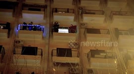 Residents in Greek city play music from their balconies to entertain locals during lockdown