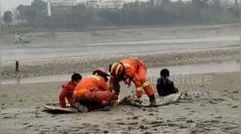 Firefighters rescue children trapped in mire near river in southern China