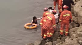 Chinese firefighters use remote-controlled lifebuoy to rescue woman drowning in river