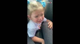 US toddler is not amused as camel sticks head through car window during safari