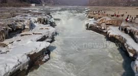 Tourists visit frozen waterfall on the Yellow River as arctic conditions grip northern China
