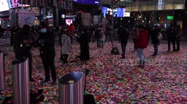 Confetti falls over an almost empty Times Square as millions watch New York's New Year's celebrations online