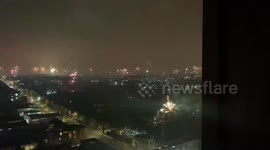 East London skyline illuminated by fireworks during New Year's celebrations