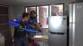 Huge cobra caught found living behind family’s fridge in Thailand