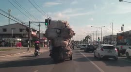 Overloaded truck sways along road in Thailand