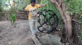 Snake handler lifts cobra out of well using rope in southern India