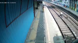 Lucky escape for commuter crossing train tracks in northwestern India