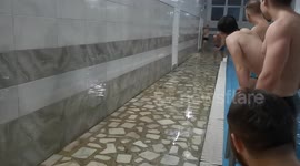 The guy slides on his stomach trying to walk the distance