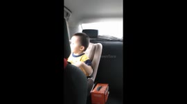 Toddler caught on camera hand-dance in car