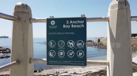 Family in Cape Town walks on beach despite it being closed to the public under new Covid lockdown regulations