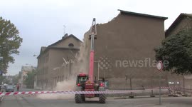 PREROV, CZECH REPUBLIC, OCTOBER 4, 2010: Demolition of preserved historical building with brickwork wall red built in 1873, Austria-Hungary. Nonsense human behavior. Special demolition excavator Manitou Maniscopic