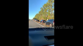 Large queues of cars as senior citizens await COVID-19 vaccination in Florida