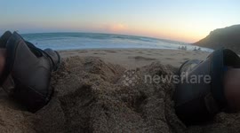 Boots in the sand on the shore of the beach at sunset. lapse of time