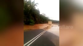 Truck gets stuck trying to drive through flooded road in Malaysia