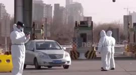 Paramedics stop vehicles entering Chinese city to check motorists' temperature amid COVID-19