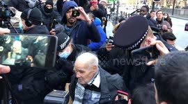 UK police detain elderly protester outside Assange bail hearing