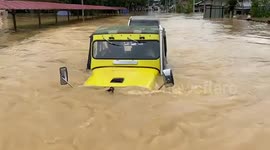 Rescue jeeps drive through flooded village in Malaysia after heavy rain
