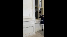 One year later: Bizarre moment Trump protester blows horn through broken windows of US Capitol