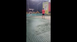 Two men hit backheel the shuttlecock continuously with their feet