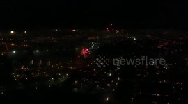 Drone in the middle of some fireworks on new years eve with a big shell