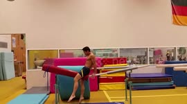 Gymnast snaps parallel bar between his legs during dismount