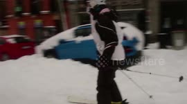 Skiers and snowboarders cruise down the streets of Madrid