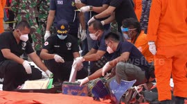 Teams examine debris possibly from downed Indonesian passenger plane