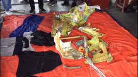Close-up footage of items found in wreckage of Indonesian plane crash