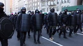 Leftist and anti-Trump protesters march through Manhattan, led by line of helmeted demonstrators carrying shields and dressed in black